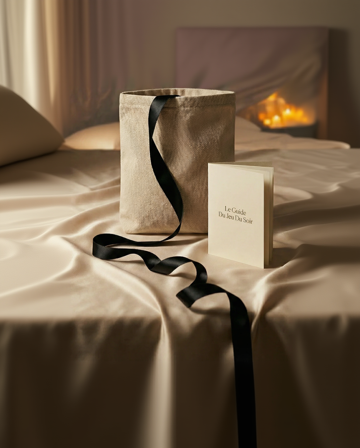 Pochette ouverte Le Jeu du Soir révélant le système ajustable, le guide illustré et les accessoires pour installation sous le matelas